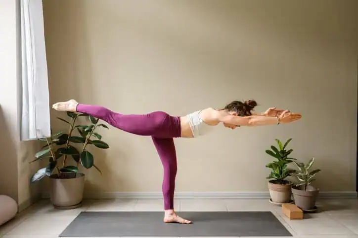 Woman doing Yoga exercise Suffolk to help with toning the body. 